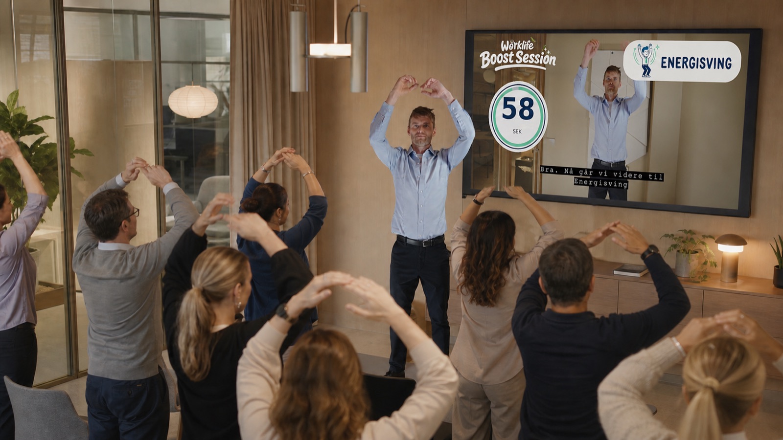Kollegaer i vanlige arbeidsklær deltar i en felles Worklife Boost Session på kontoret